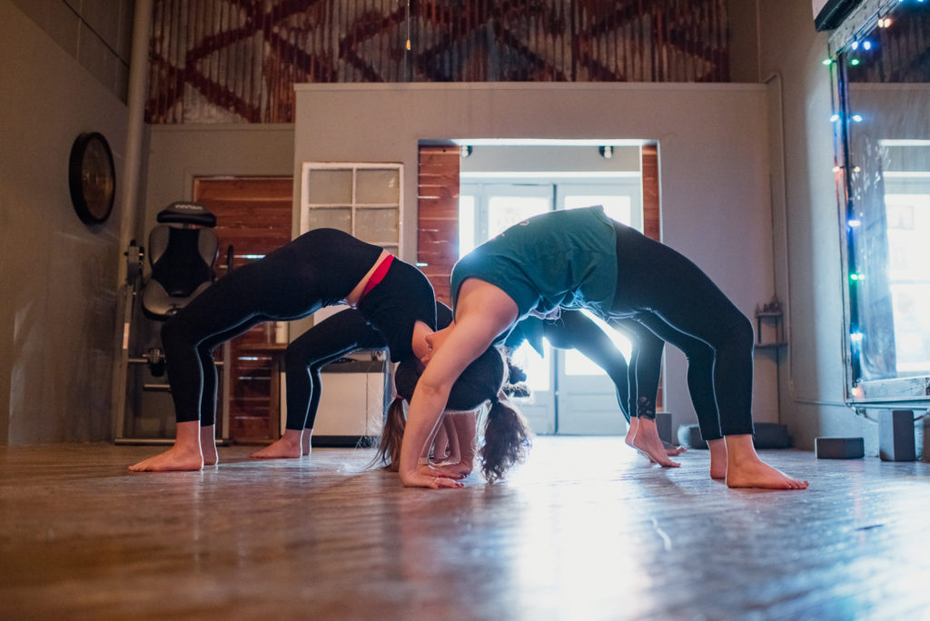 the girls bending backwards in the yoga studio